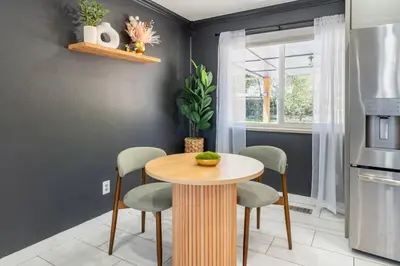 a kitchen with a wooden table and four chairs at Spacious 5BR, Epic Backyard, Perfect Gatherings in Arvada