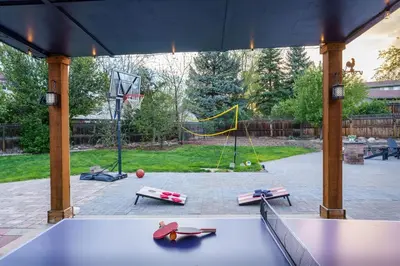 a ping pong table in a pavilion with a playground at Spacious 5BR, Epic Backyard, Perfect Gatherings in Arvada