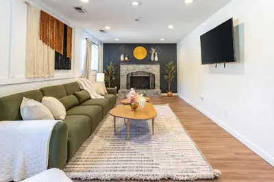a living room with a green couch and a fireplace at Spacious 5BR, Epic Backyard, Perfect Gatherings in Arvada