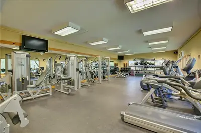 a gym with lots of tread machines and a flat screen tv at Luxury Stay Meets Family Fun- Premier 1BR Retreat condo in Keystone