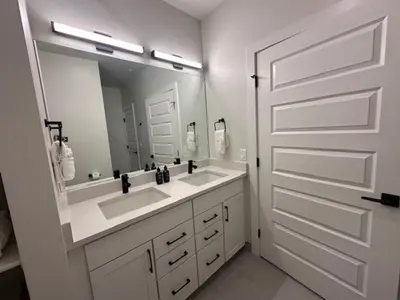 a bathroom with two sinks and a large mirror at Luxury Stay Meets Family Fun- Premier 1BR Retreat condo in Keystone