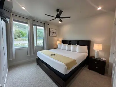 a bedroom with a large bed with a ceiling fan at Luxury Stay Meets Family Fun- Premier 1BR Retreat condo in Keystone