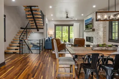 a dining room and living room with a table and chairs at Blue Horizon Chalet home in Winter Park