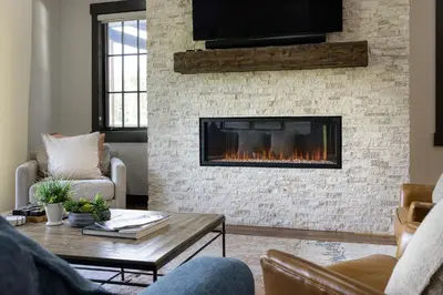 a living room with a fireplace with a tv at Blue Horizon Chalet home in Winter Park