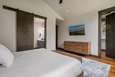 a bedroom with a large bed and a bathroom at Blue Horizon Chalet home in Winter Park