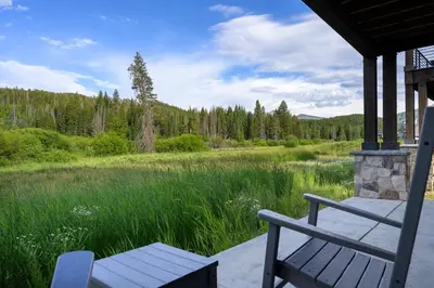 a bench on a porch with a view of a lake at Blue Horizon Chalet home in Winter Park