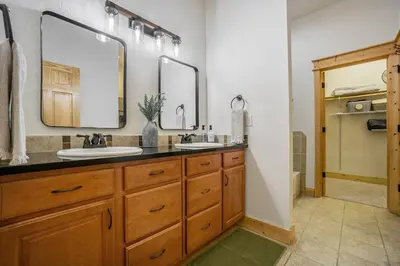 a bathroom with two sinks and a large mirror at Estes Park Luxury Family Retreat in Estes Park
