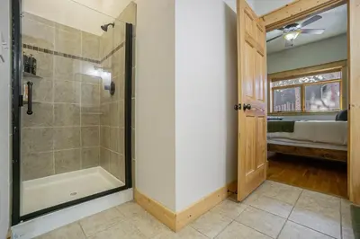 a bathroom with a shower with a glass door at Estes Park Luxury Family Retreat in Estes Park