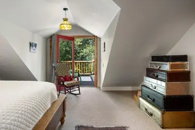 a bedroom with a bed with a stack of suitcases at The River House home in Grand Lake