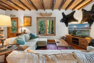 a living room with a couch and a tv at The River House home in Grand Lake