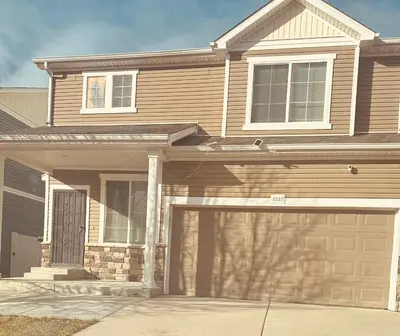 a house with a garage door in front of it at Yedengel in DEN