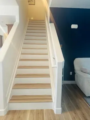 a white staircase in a room with blue walls at Yedengel in DEN