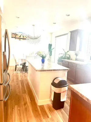 a kitchen with a kitchen island with a trash can at Yedengel in DEN