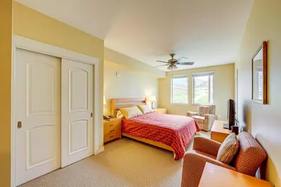 a bedroom with a bed and a ceiling fan at 100 Steps to Gondola Cozy Winter Park Condo! in Winter Park