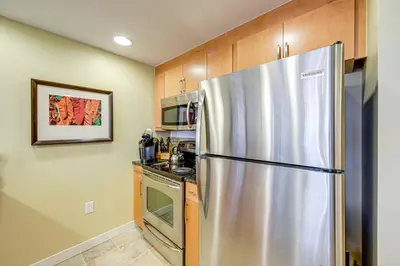 a kitchen with a stainless steel refrigerator at 100 Steps to Gondola Cozy Winter Park Condo! in Winter Park