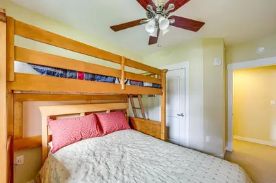 a bedroom with a bunk bed and a ceiling fan at 100 Steps to Gondola Cozy Winter Park Condo! in Winter Park