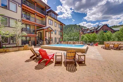 a patio with chairs and a swimming pool at 100 Steps to Gondola Cozy Winter Park Condo! in Winter Park