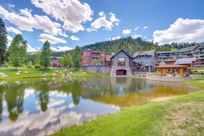 a village with a lake in the middle at 100 Steps to Gondola Cozy Winter Park Condo! in Winter Park