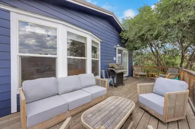 a porch with a couch and chairs on a house at Large House On Horsetooth Reservoir - Great Views! in Fort Collins