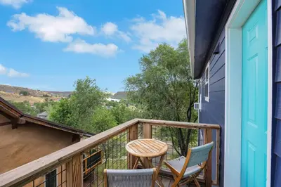 a balcony with two chairs and a table at Large House On Horsetooth Reservoir - Great Views! in Fort Collins