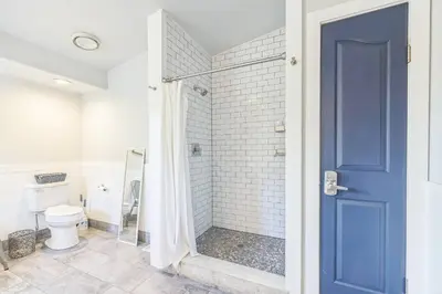 a bathroom with a shower with a blue door at Large House On Horsetooth Reservoir - Great Views! in Fort Collins