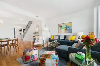 a living room with a blue couch and a table at The Overlook - Luxe Old Town Condo with King Suite in Fort Collins
