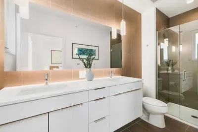 a bathroom with a white sink and a toilet at The Overlook - Luxe Old Town Condo with King Suite in Fort Collins