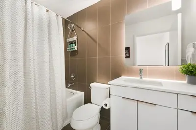a bathroom with a white toilet and a sink at The Overlook - Luxe Old Town Condo with King Suite in Fort Collins