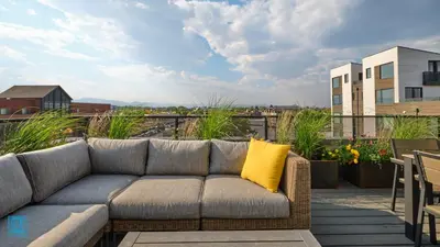 a couch sitting on top of a patio at The Overlook - Luxe Old Town Condo with King Suite in Fort Collins