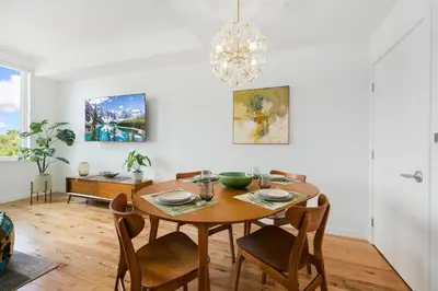 a dining room with a wooden table and chairs at The Overlook - Luxe Old Town Condo with King Suite in Fort Collins