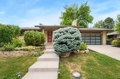 a house with a driveway and a tree at The Foundry Escape - Hot Tub, Bikes & Game Room in Loveland