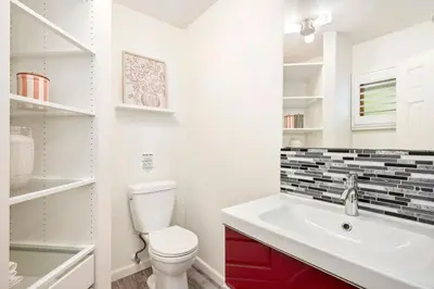 a bathroom with a white toilet and a sink at The Foundry Escape - Hot Tub, Bikes & Game Room in Loveland