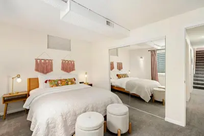 a bedroom with two beds and a mirror at The Foundry Escape - Hot Tub, Bikes & Game Room in Loveland