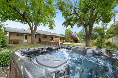 a backyard pool with a hot tub in the yard at The Foundry Escape - Hot Tub, Bikes & Game Room in Loveland