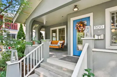 a front door of a house with a wreath on it at Maple Courtyard - Old Town with King Suite & Piano in Fort Collins