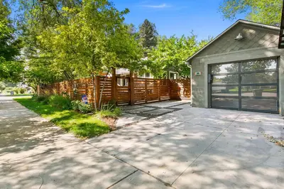 a house with a garage and a fence at Maple Courtyard - Old Town with King Suite & Piano in Fort Collins