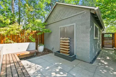 a small building with a bench next to it at Maple Courtyard - Old Town with King Suite & Piano in Fort Collins