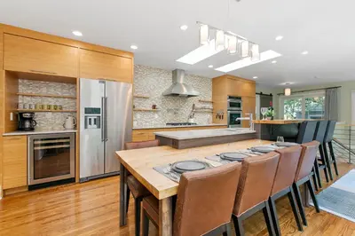 a kitchen with a large wooden table and chairs at Maple Courtyard - Old Town with King Suite & Piano in Fort Collins