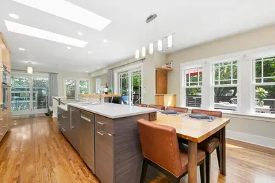 a large kitchen with a wooden table and chairs at Maple Courtyard - Old Town with King Suite & Piano in Fort Collins