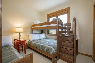 a bedroom with a bunk bed and a window at Cloudline Chalet townhouse in Winter Park