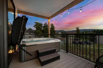 a jacuzzi tub on a deck with a sunset at 281 W Meadow Mile #4 in Fraser