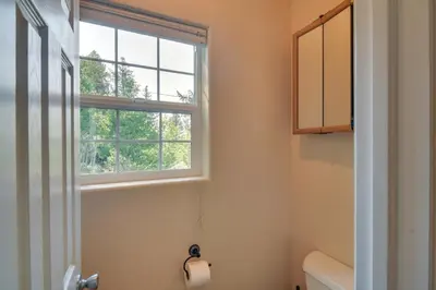 a bathroom with a toilet and a window at Mountain-View Conifer Gem Near Hiking and Fishing in Conifer