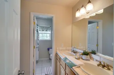 a bathroom with two sinks and a large mirror at Mountain-View Conifer Gem Near Hiking and Fishing in Conifer