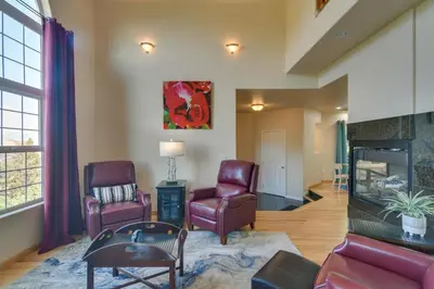 a living room with two chairs and a fireplace at Mountain-View Conifer Gem Near Hiking and Fishing in Conifer