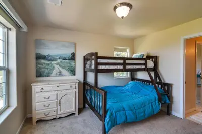 a bedroom with two bunk beds and a dresser at Mountain-View Conifer Gem Near Hiking and Fishing in Conifer