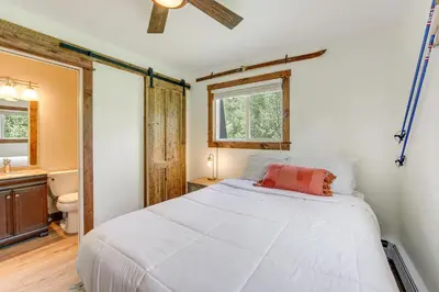 a bedroom with a white bed and a bathroom at Dine, Shop and Shuttle to Resort Winter Park Haven! in Winter Park