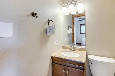a bathroom with a sink and a toilet and a mirror at Dine, Shop and Shuttle to Resort Winter Park Haven! in Winter Park