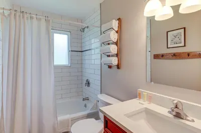 a bathroom with a sink and a toilet and a tub at Dine, Shop and Shuttle to Resort Winter Park Haven! in Winter Park