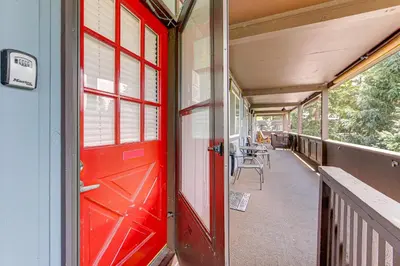 a red door on the side of a building at Dine, Shop and Shuttle to Resort Winter Park Haven! in Winter Park