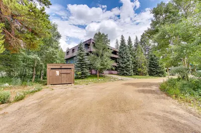 a dirt road in front of a house at Dine, Shop and Shuttle to Resort Winter Park Haven! in Winter Park